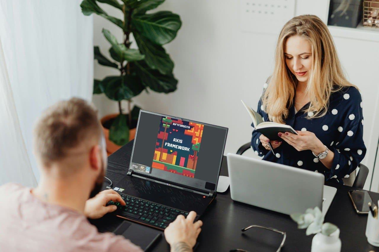 People learning with laptops displaying Java game development course "Axis Framework"