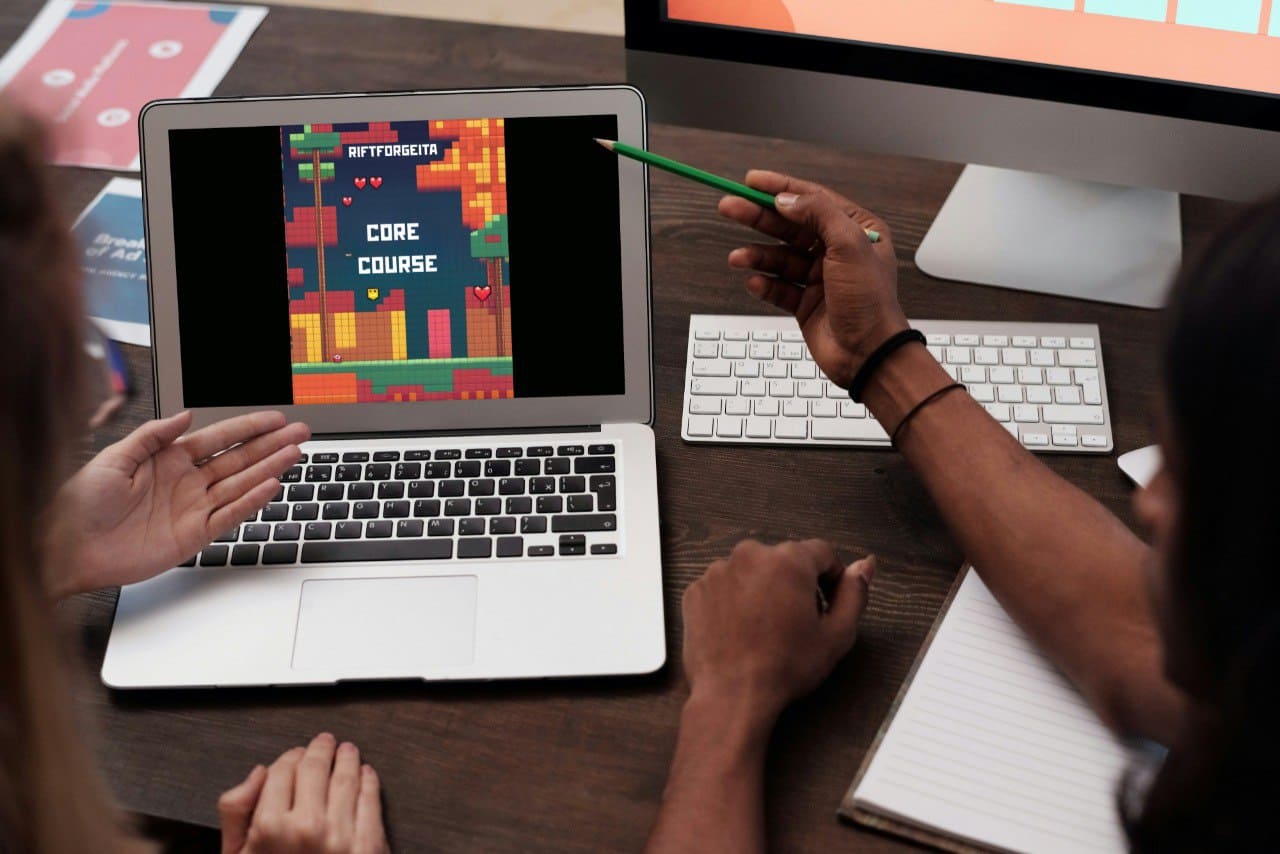 People studing on laptop  displaying Java game development course "Core Course"