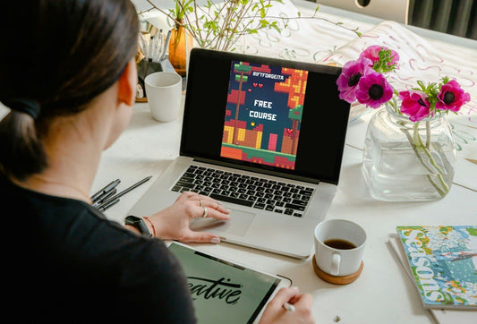 Laptop displaying Java game development course "Free Course"