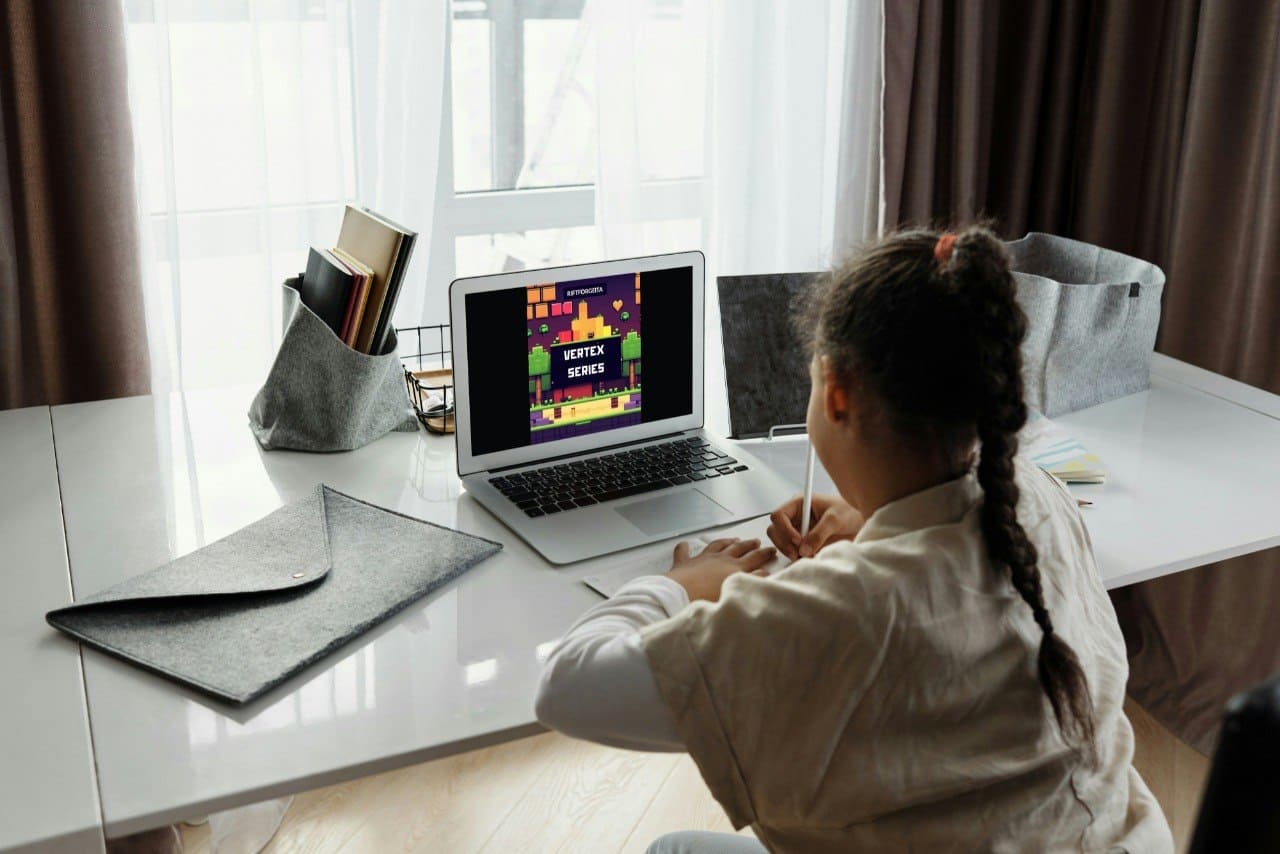 Laptop displaying Java game development course "Vertex Series"